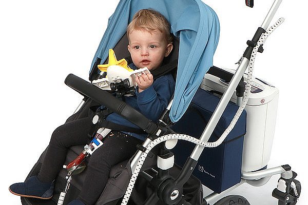 Child with heart pump in stroller