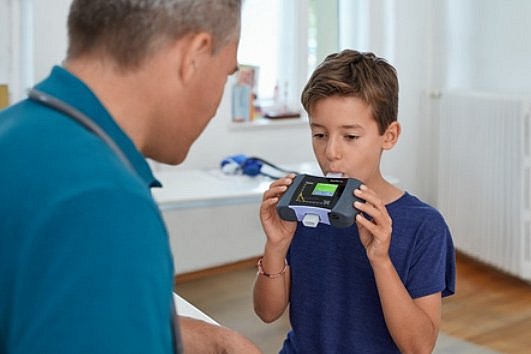 Child taking a lung function test