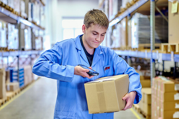 An employee scans the QR code on a package